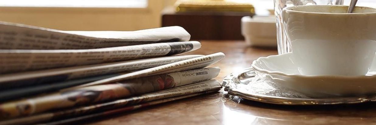 Newspapers with a Cup of Coffee